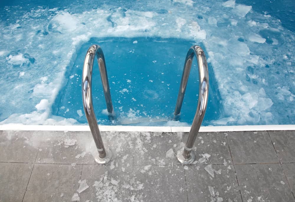 Steps in the frozen blue pool ice-hole - Winter Time and your Pool - What you should Know